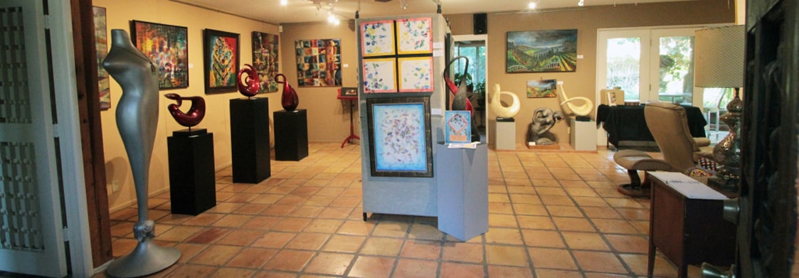 Gallery interior with terracotta floor and warm lighting